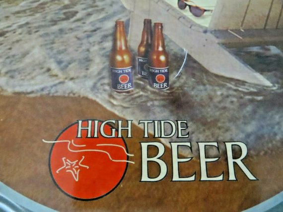 high-tide-beer-bottle-cap-tin-bar-sign-chair-on-the-beach-sand-on-ocean