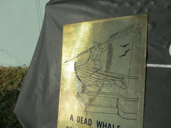 a-dead-whale-or-a-stove-boat-guy-on-front-of-boat-harpooning-brass-sign