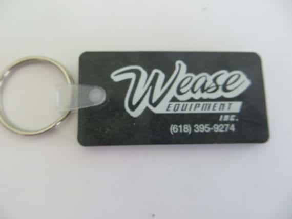 Wease Equipment Inc, advertising black rubber collectible key chain